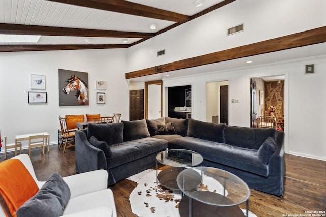 living room featuring lofted ceiling with beams and dark hardwood / wood-style floors