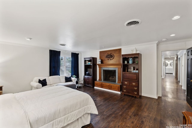 bedroom featuring ornamental molding and dark wood-type flooring