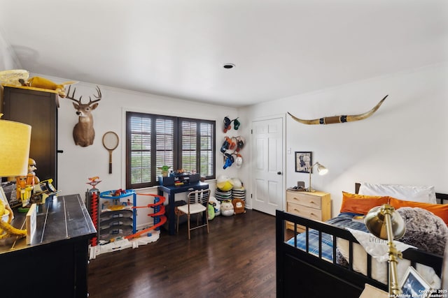 bedroom with dark hardwood / wood-style flooring