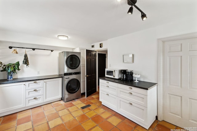 laundry area with stacked washer / drying machine