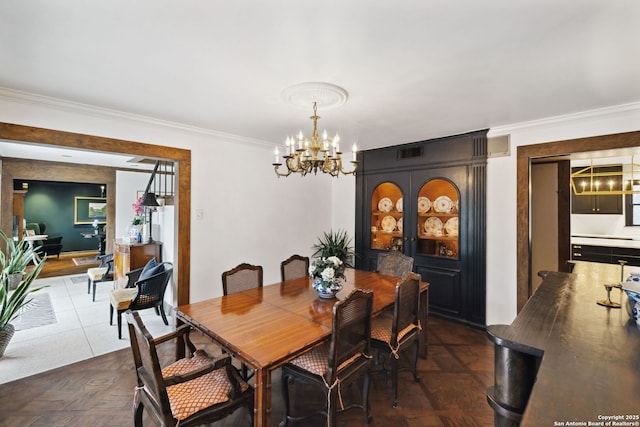 dining area featuring ornamental molding, dark parquet floors, and a chandelier