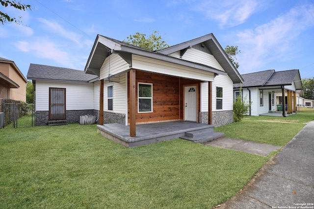 view of front of house featuring a front yard, covered porch, and cooling unit