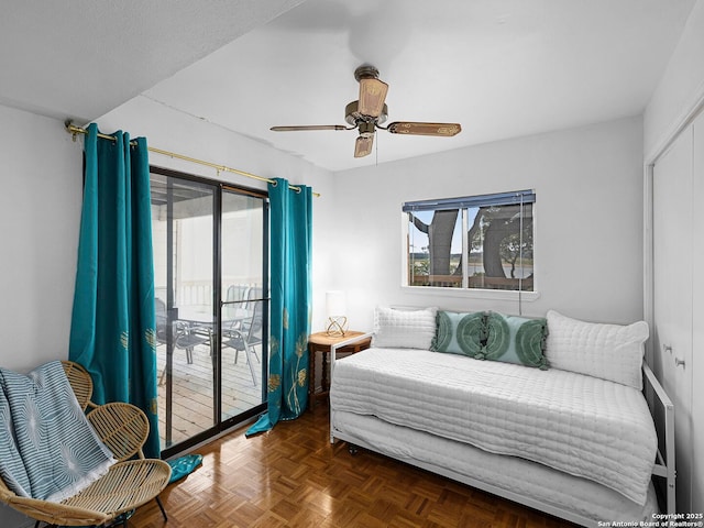 1048 Parkview Dr, Canyon Lake, TX 78133 - bedroom with ceiling fan, access to exterior, and dark parquet floors