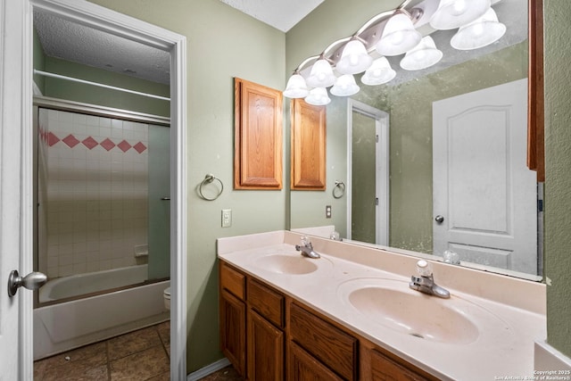 full bathroom with toilet, a textured ceiling, vanity, enclosed tub / shower combo, and tile patterned flooring