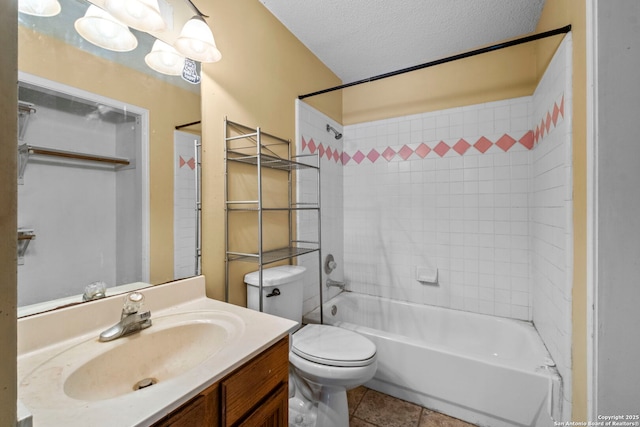 full bathroom featuring tiled shower / bath, vanity, toilet, tile patterned floors, and a textured ceiling