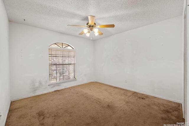 carpeted spare room featuring ceiling fan and a textured ceiling