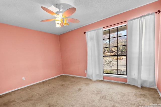 carpeted empty room featuring ceiling fan and a textured ceiling