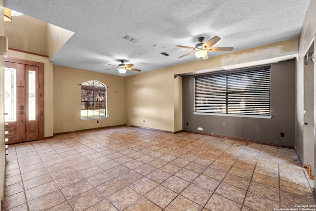 spare room with ceiling fan and a textured ceiling