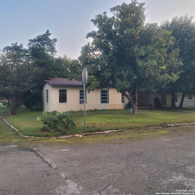 view of side of property with a lawn