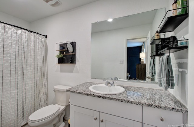 bathroom with vanity and toilet