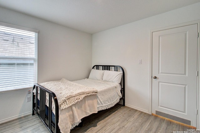 bedroom with light hardwood / wood-style flooring