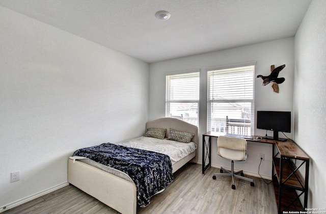 bedroom with light hardwood / wood-style floors