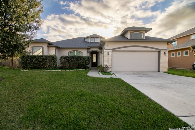 view of front facade with a garage and a front yard