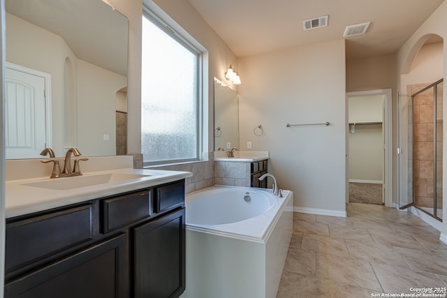 full bath featuring two vanities, a sink, and visible vents