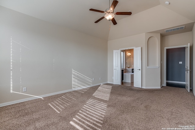 carpeted empty room with a ceiling fan, visible vents, high vaulted ceiling, and baseboards