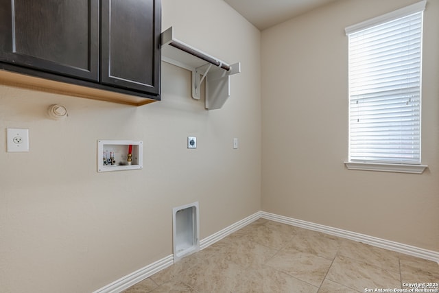 clothes washing area with washer hookup, cabinet space, hookup for an electric dryer, gas dryer hookup, and baseboards