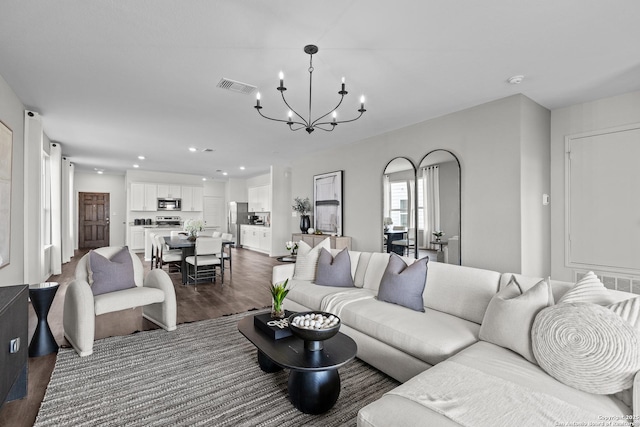 living room featuring a notable chandelier and dark hardwood / wood-style floors