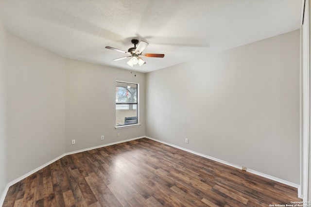 empty room featuring ceiling fan, a textured ceiling, and dark hardwood / wood-style flooring