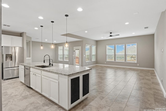 kitchen with white cabinetry, sink, an island with sink, and appliances with stainless steel finishes