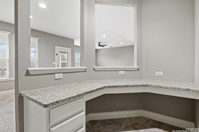 bathroom featuring a healthy amount of sunlight, tile patterned floors, and ceiling fan