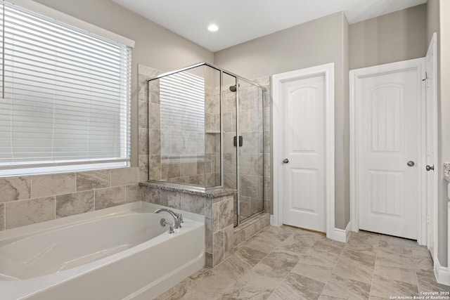 bathroom featuring shower with separate bathtub