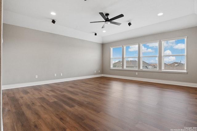 unfurnished room featuring dark wood-type flooring and ceiling fan