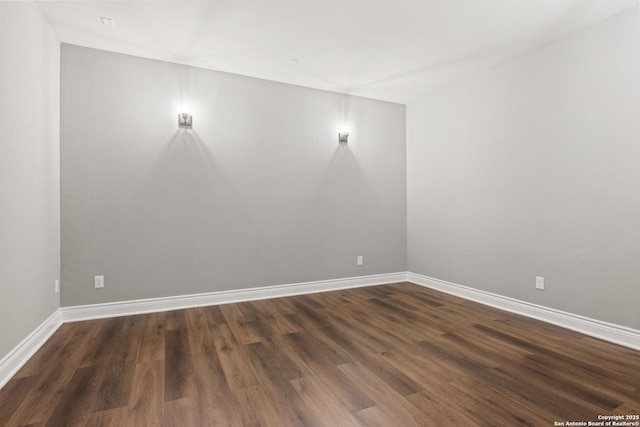 empty room with dark hardwood / wood-style flooring