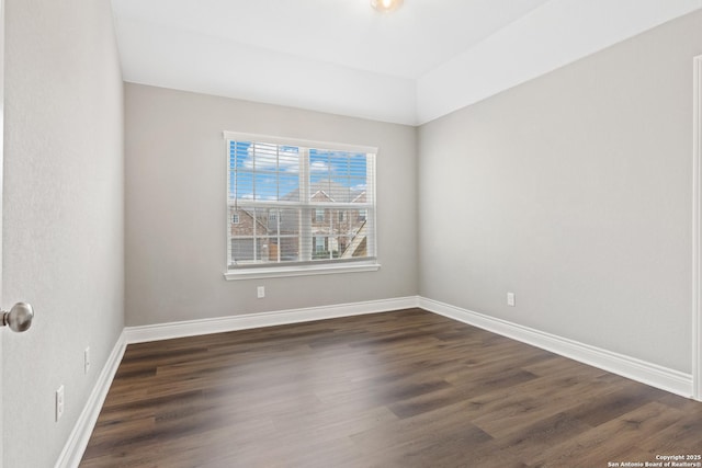 spare room featuring dark hardwood / wood-style flooring