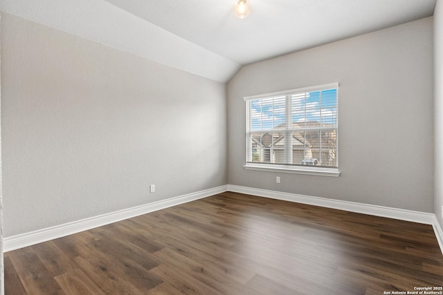 unfurnished room with lofted ceiling and dark hardwood / wood-style floors