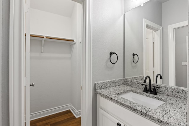 bathroom featuring hardwood / wood-style flooring and vanity