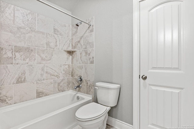 bathroom featuring toilet and tiled shower / bath combo