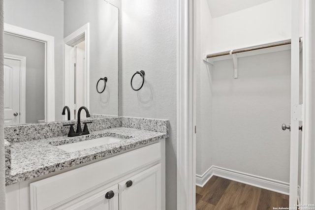 bathroom with vanity and hardwood / wood-style flooring