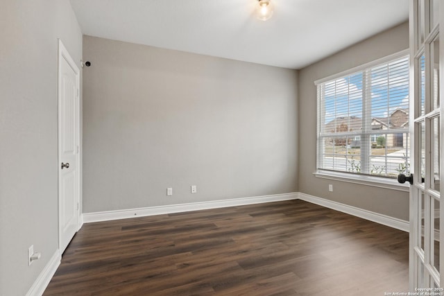 unfurnished room with french doors and dark hardwood / wood-style floors