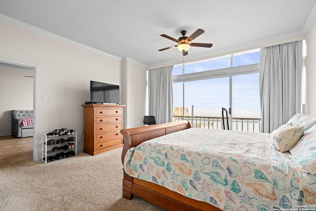 carpeted bedroom featuring crown molding, access to outside, ceiling fan, and a wall of windows