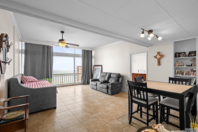 tiled dining area with crown molding, floor to ceiling windows, built in features, and ceiling fan