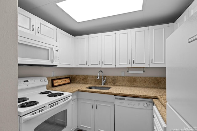 kitchen with white cabinetry, white appliances, and sink