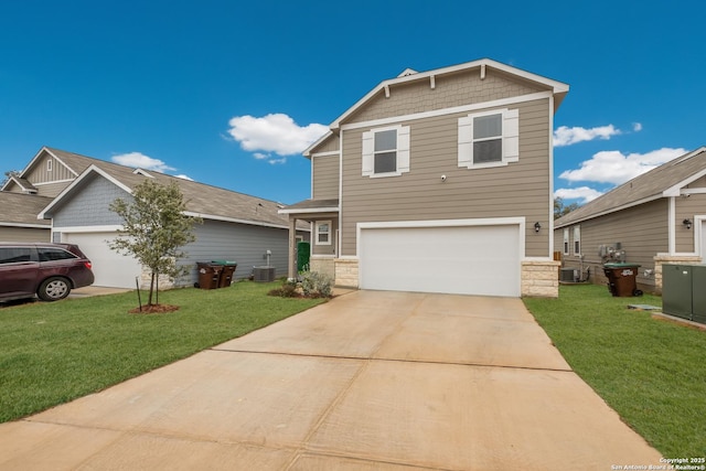 view of front of home with a garage, cooling unit, and a front lawn