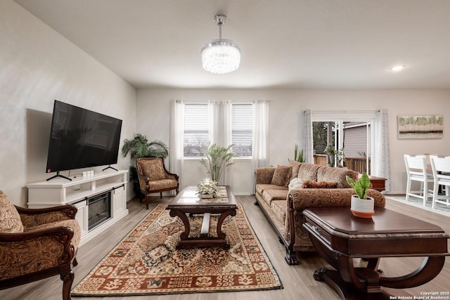 living room with plenty of natural light and light hardwood / wood-style floors