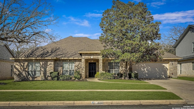 view of front of home featuring a garage and a front lawn