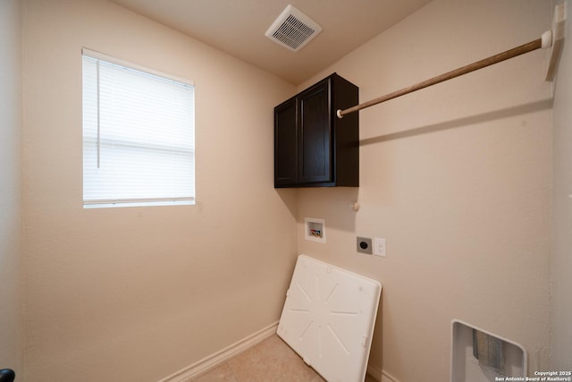 clothes washing area featuring cabinets, light tile patterned flooring, electric dryer hookup, and hookup for a washing machine