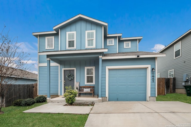 view of front property with a garage, a front lawn, and a porch