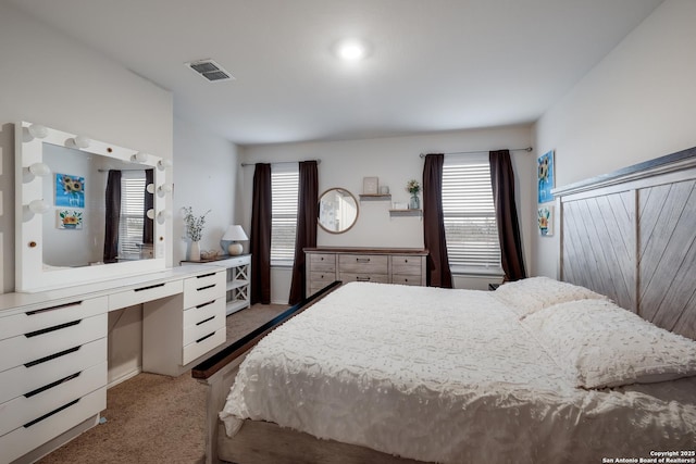 carpeted bedroom featuring multiple windows