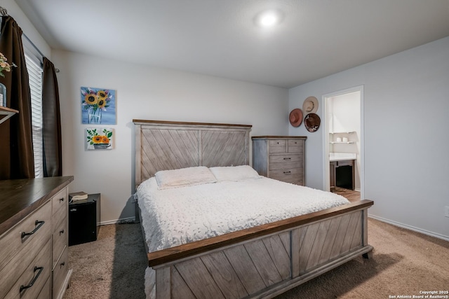 carpeted bedroom featuring ensuite bath