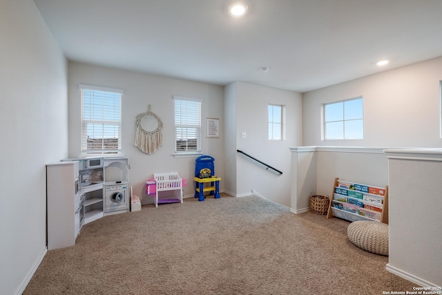 game room with plenty of natural light and carpet flooring