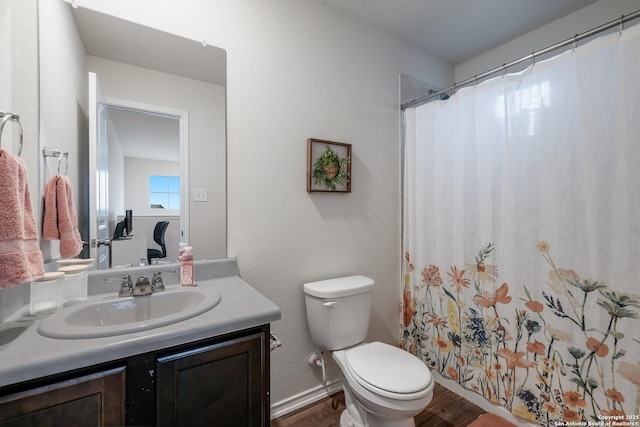 bathroom featuring vanity, hardwood / wood-style floors, and toilet