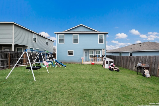 back of property with a playground and a lawn