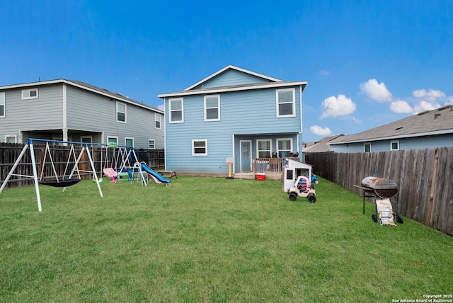 rear view of property featuring a playground and a lawn