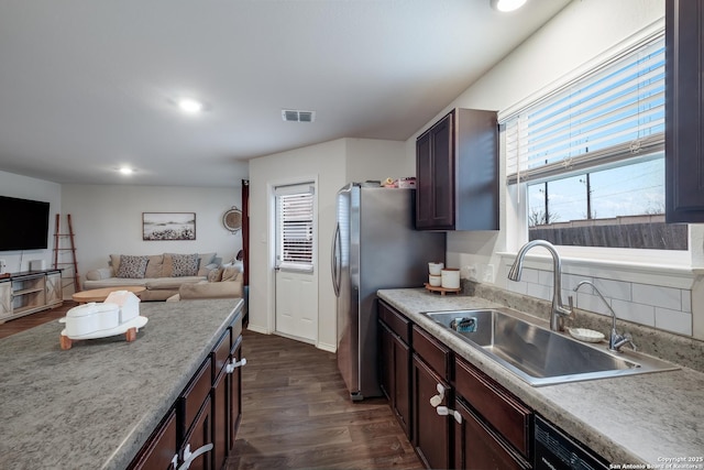 kitchen with sink, tasteful backsplash, dark brown cabinets, stainless steel fridge, and dark hardwood / wood-style flooring