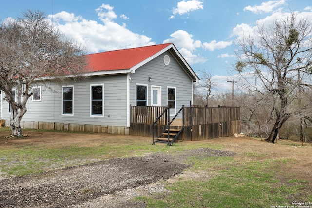 view of side of property featuring a yard and a deck