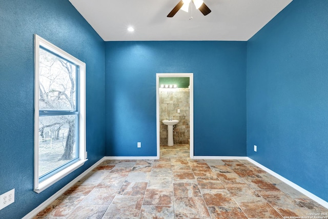 unfurnished room with sink and ceiling fan
